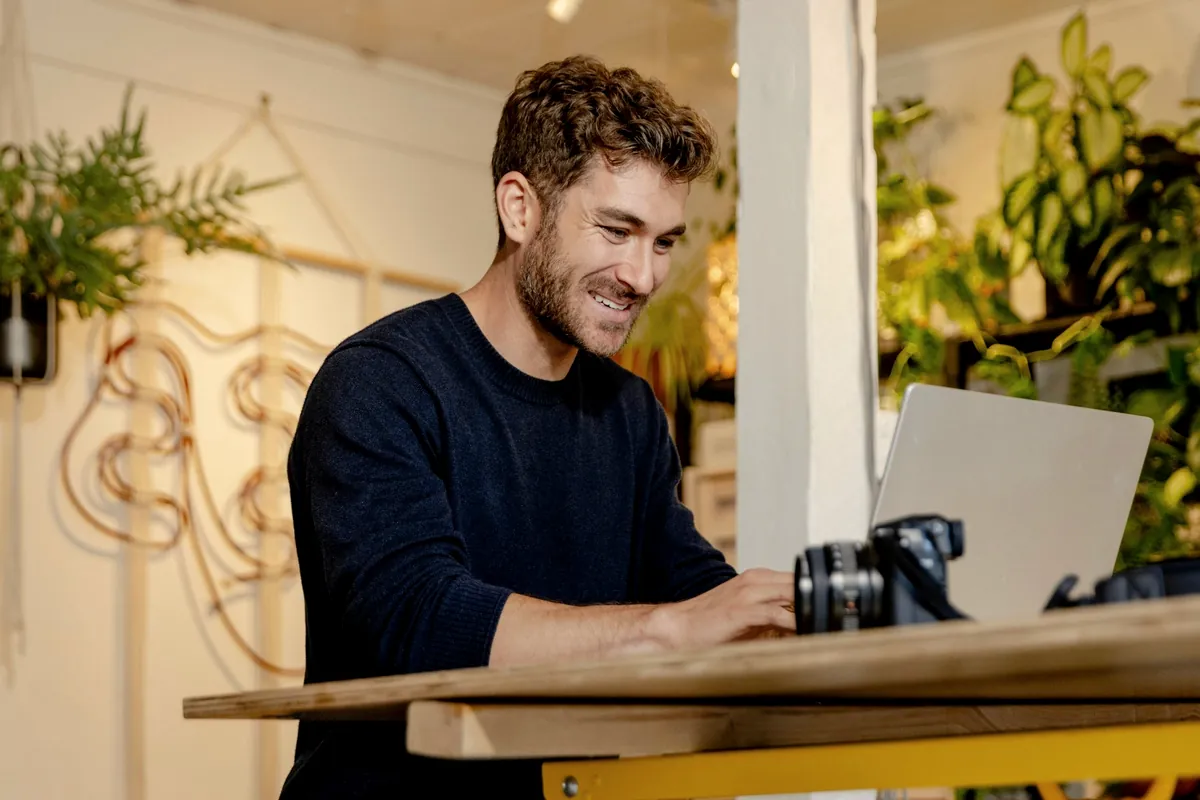 Adult learner smiling while studying on his laptop